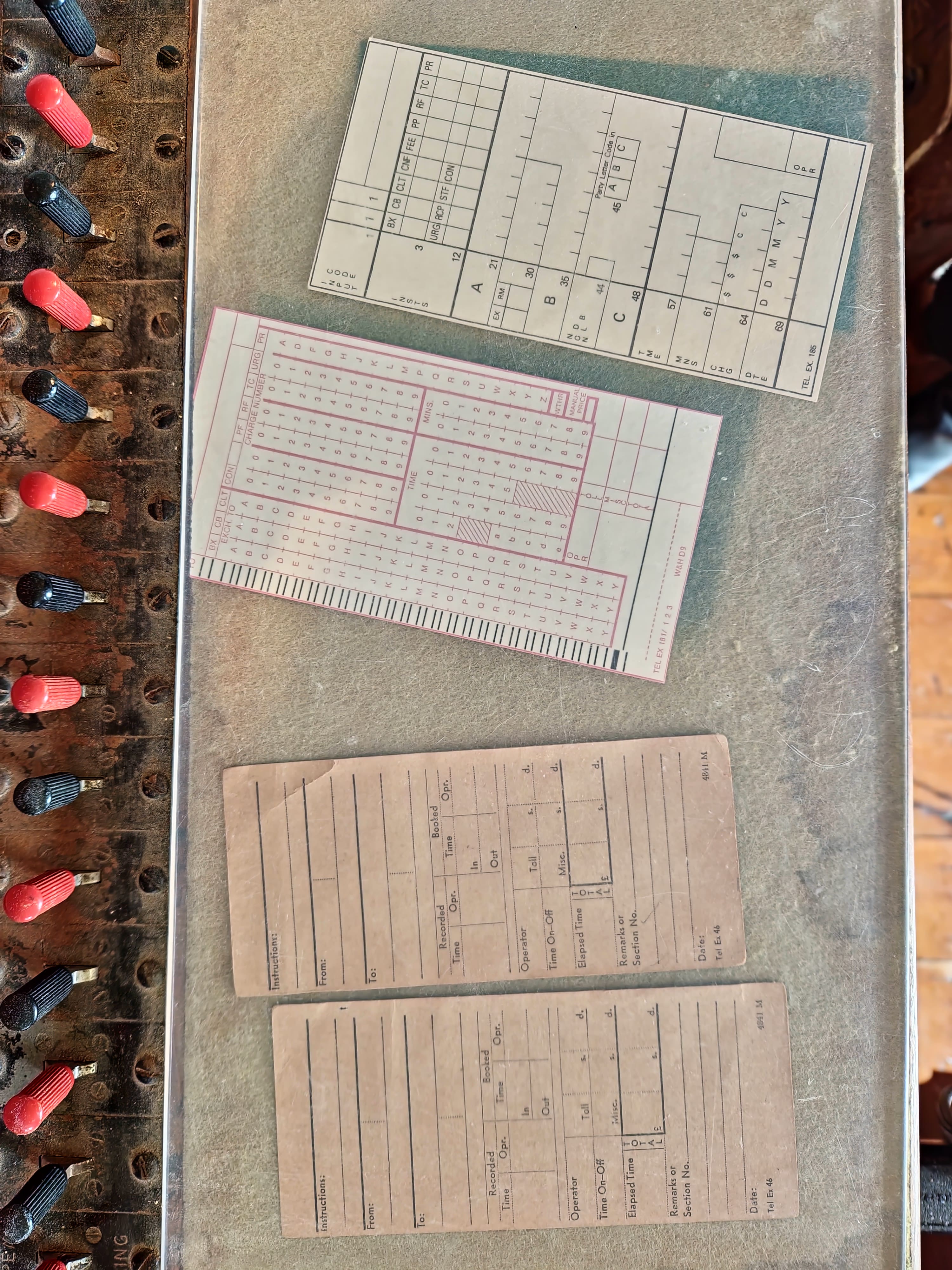 Large standing wooden switchboard with many plugs and wires.